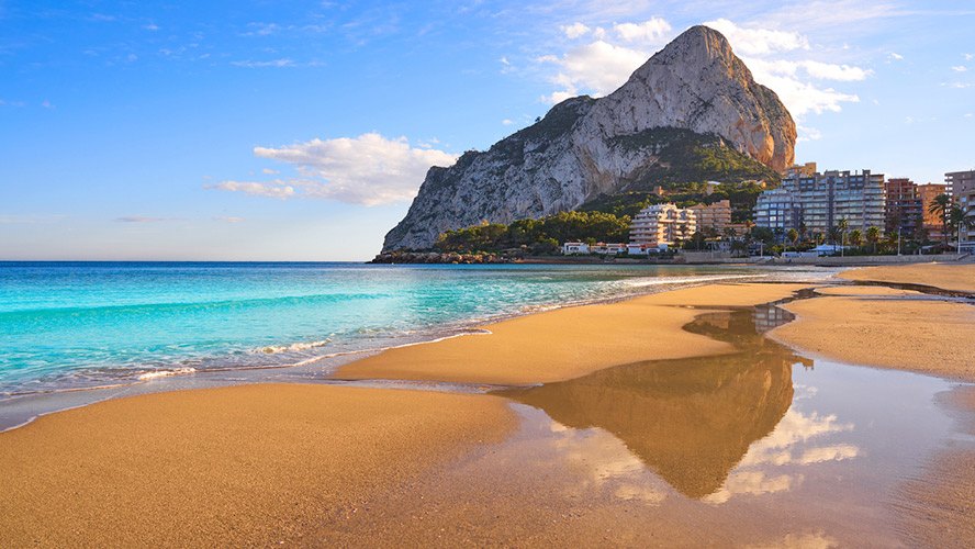 The Peñón de Ifach rock rising from the sea next to Calpe beach on the Costa Blanca